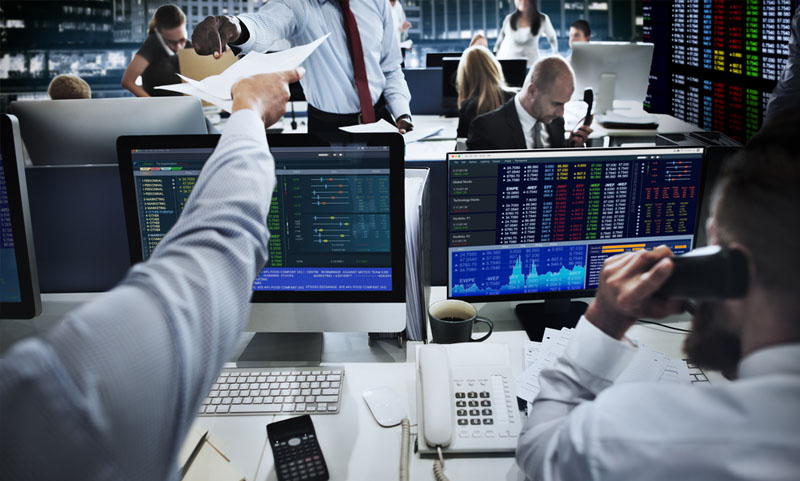 Capital markets workers at a screen